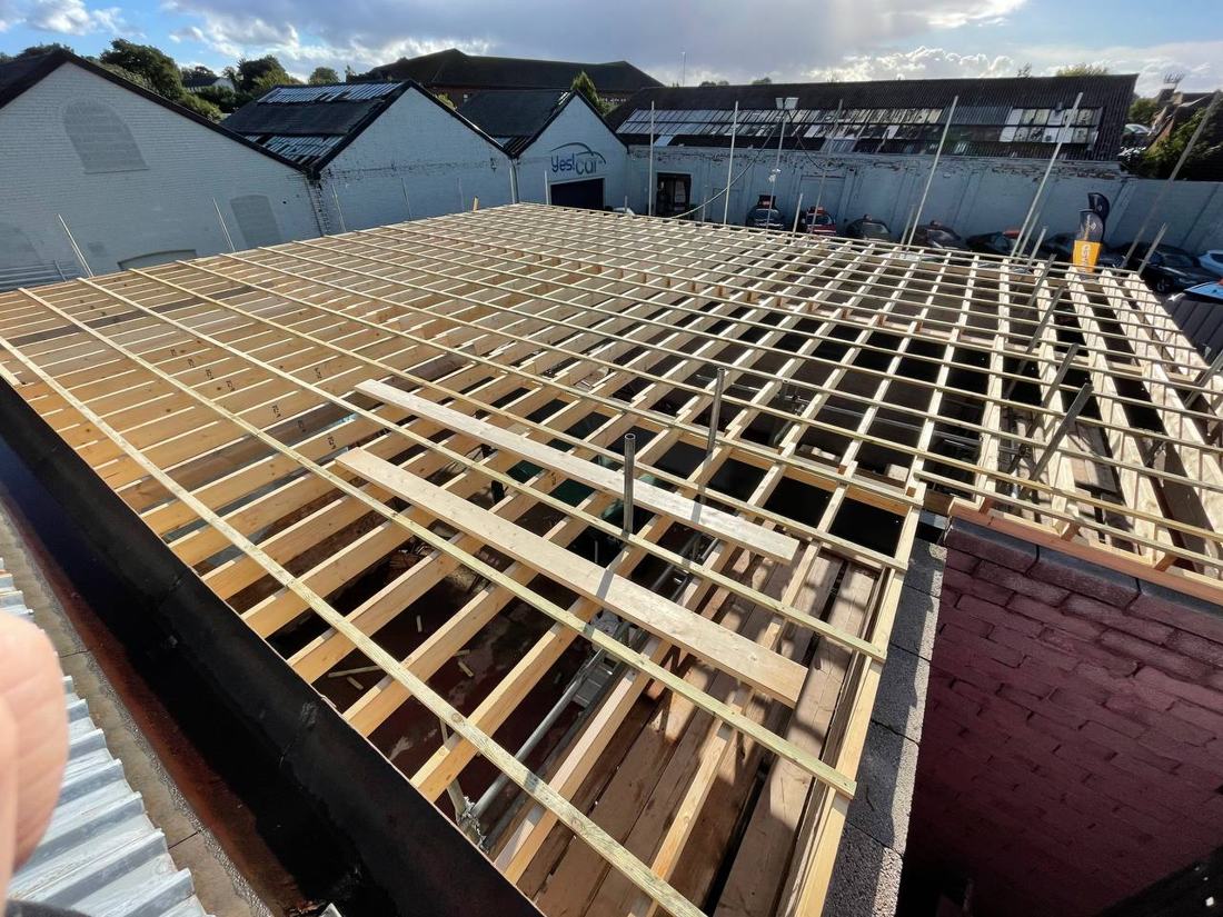 Large flat roof joists being fitted on a commercial building