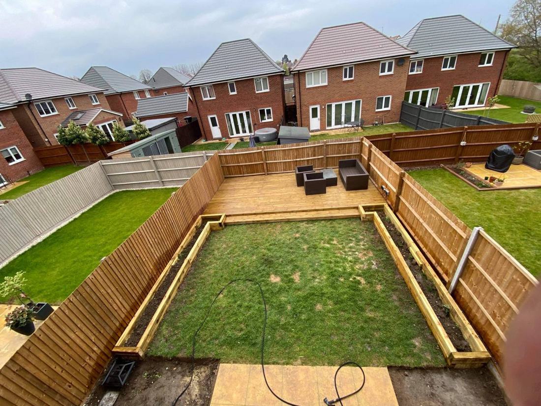 Garden with new sleeper raised beds, decking and fencing